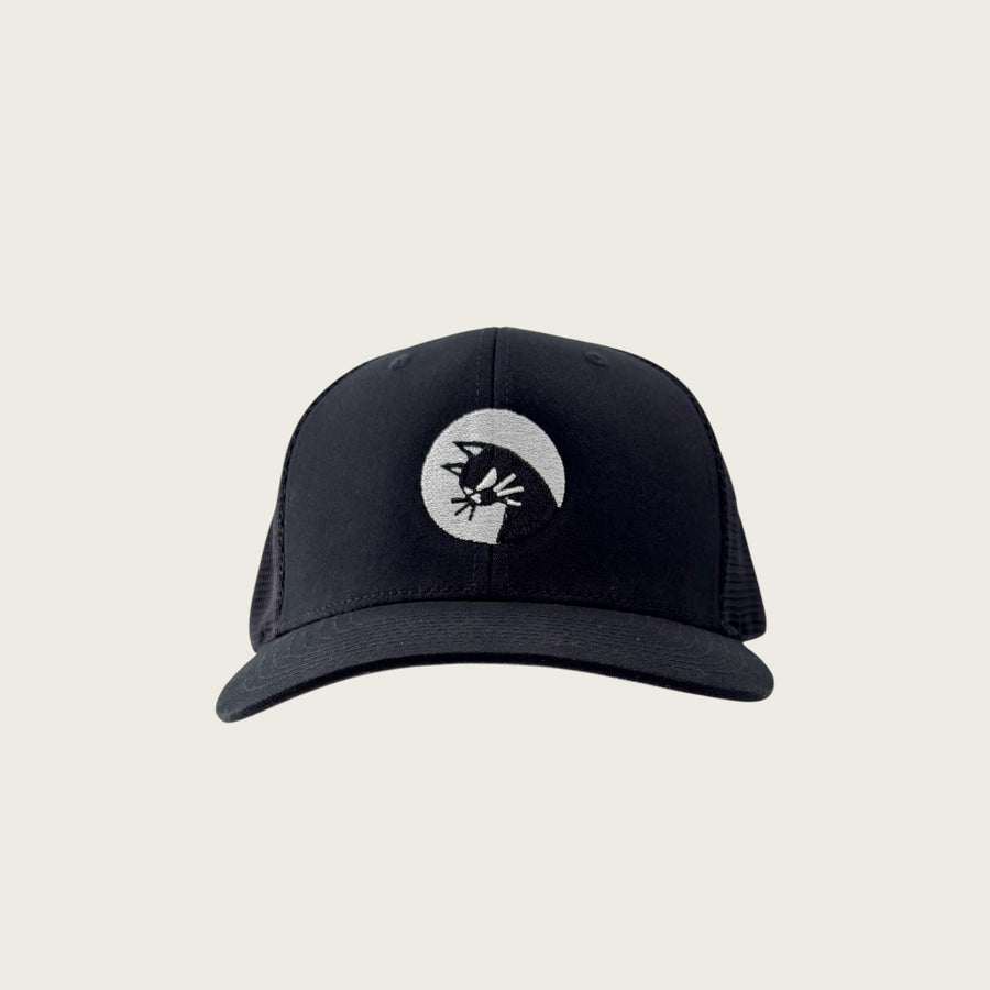 Bad Cat mesh-back trucker cap in black, front view, embroidered cat mark