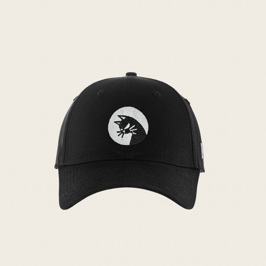 Bad Cat — black six-panel cap, front view with the restless cat badge embroidered in white